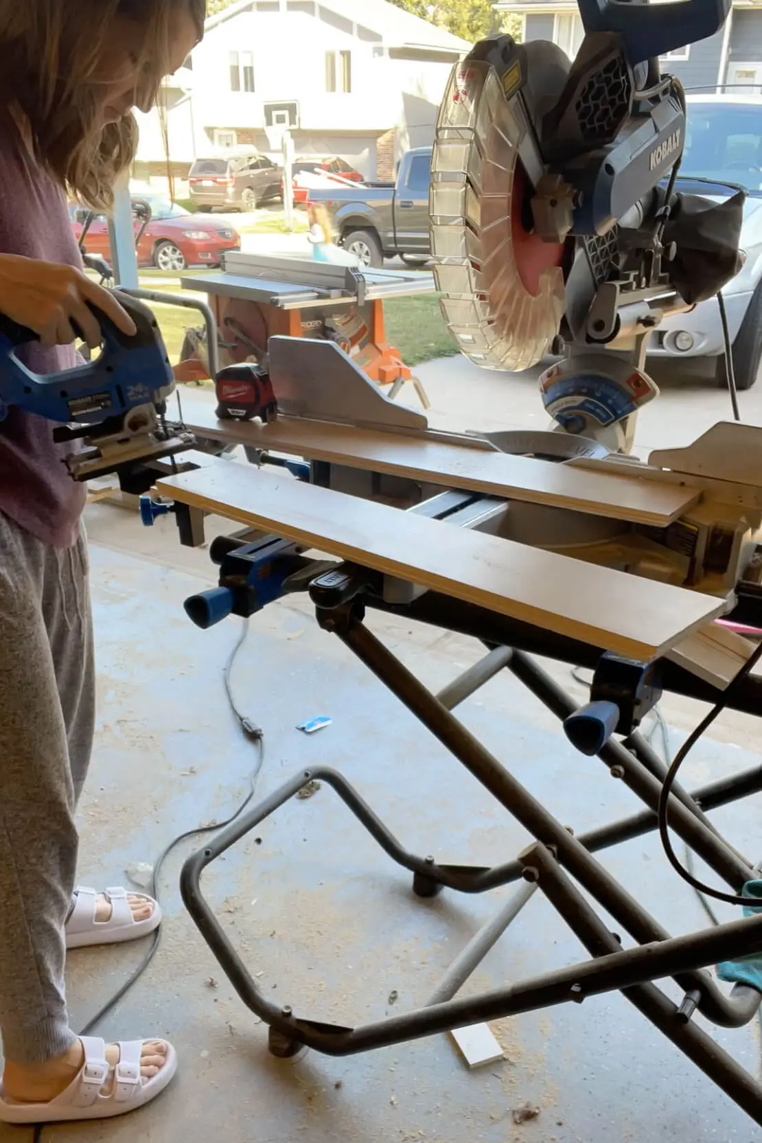 Using a jigsaw to cut a shiplap backsplash.